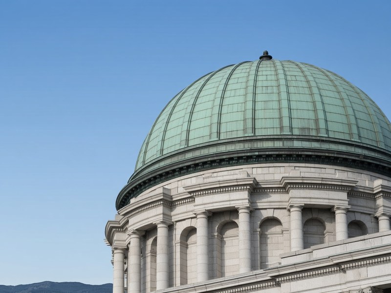 The dome of the Utah State Capitol against a blue sky.
