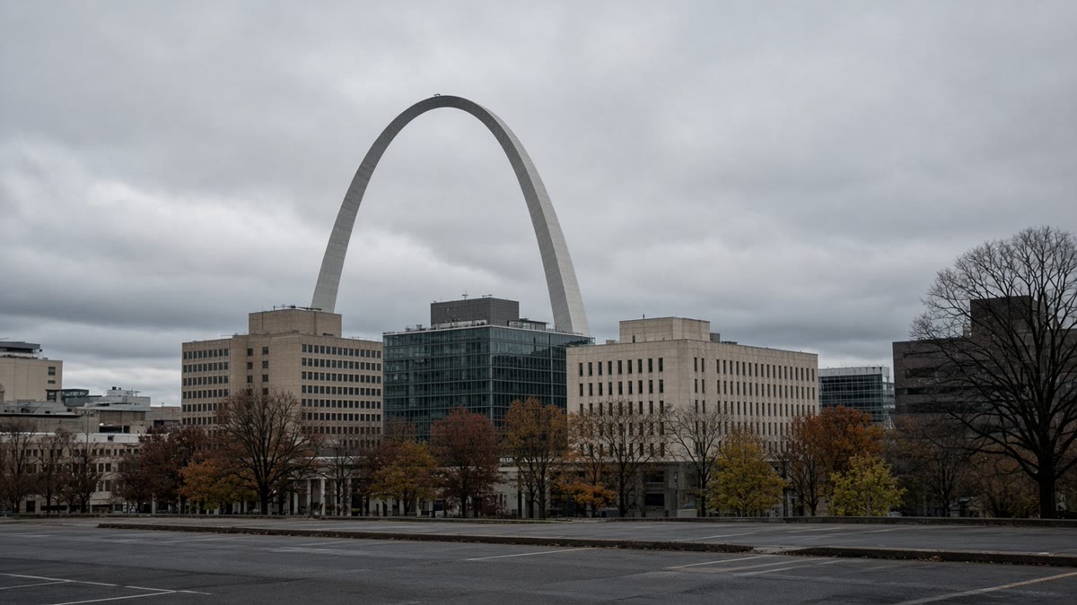 The Gateway Arch rising behind downtown St. Louis on an overcast morning.